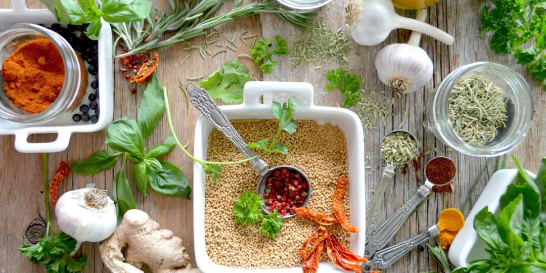 Unterschiedliche ayurvedische Gewürze und Kräuter auf einem Tisch